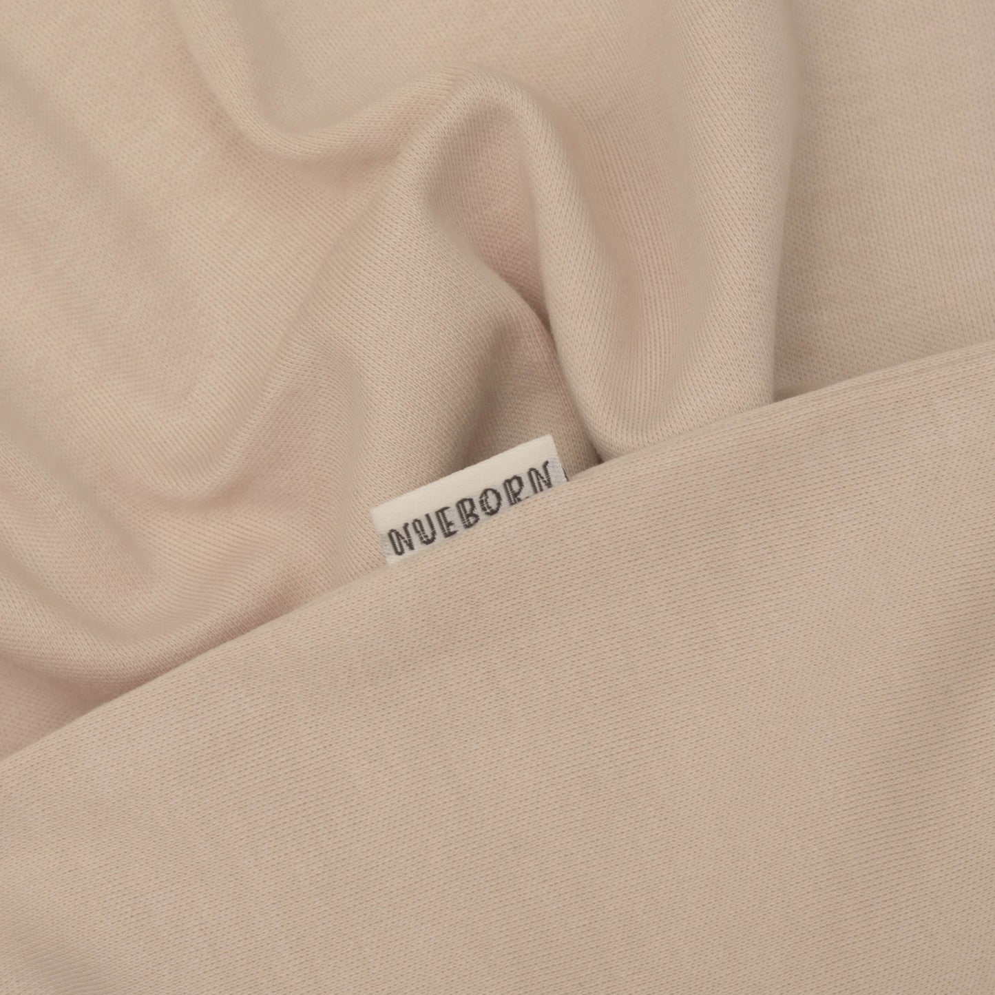 nueborn sleepsuit in Sandstone