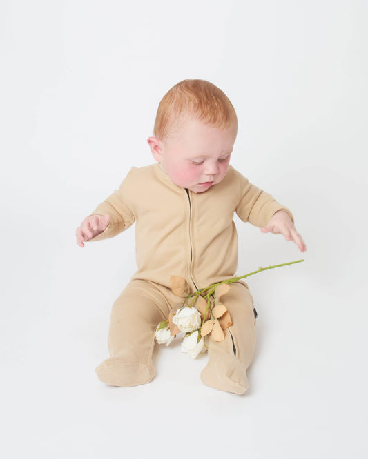 baby wearing the khaki nueborn sleepsuit