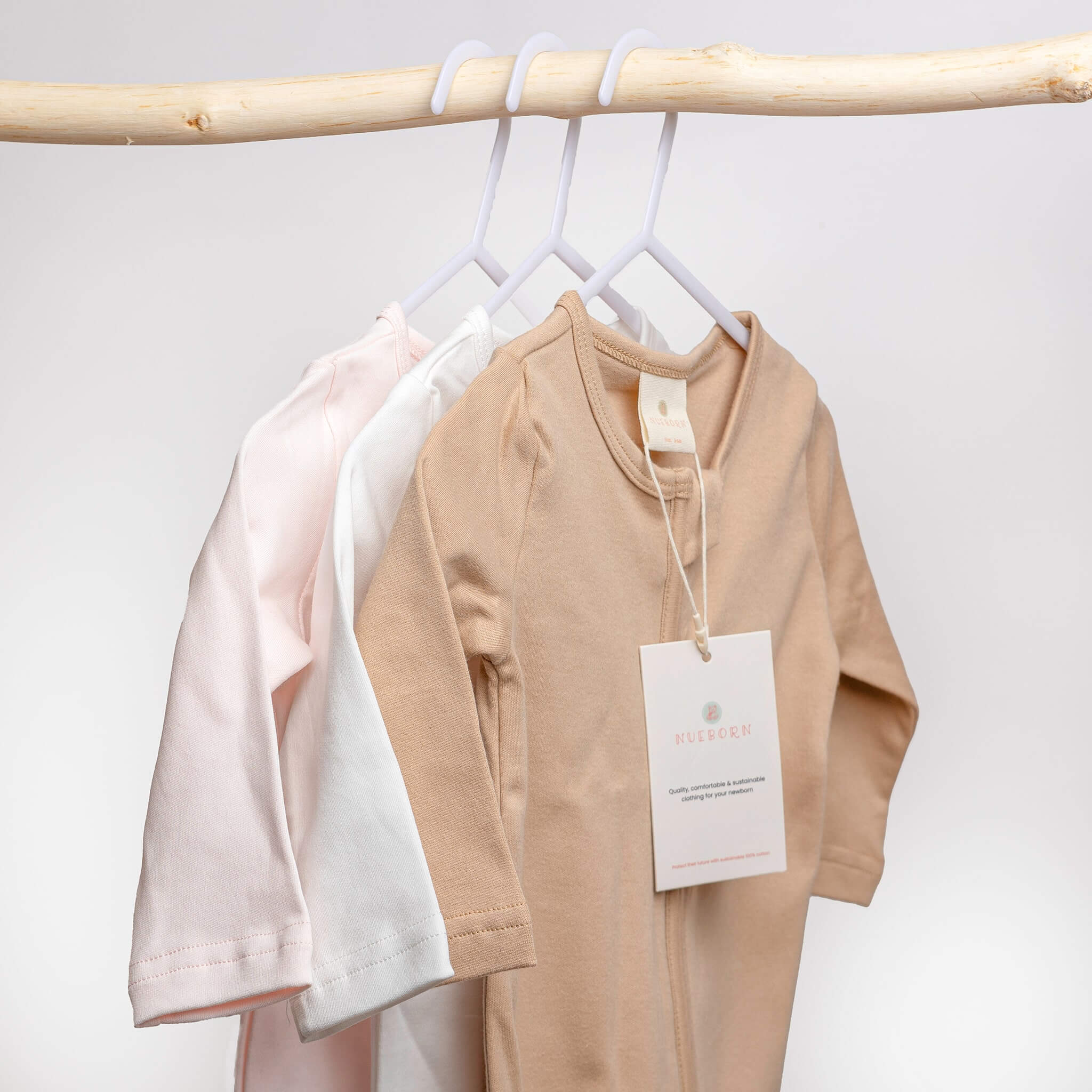 nueborn clothing colour range, khaki, pink and white