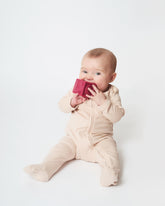 baby wearing the sandstone nueborn sleepsuit